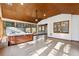 Sunroom with a hot tub and vaulted ceiling, featuring large windows and tile flooring at 3562 Ontario Ct, Buford, GA 30519