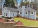 Gray house with landscaped yard, stone wall, and walkway at 38 Timberlost Trl, Suwanee, GA 30024