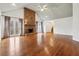 Spacious living room with hardwood floors, stone fireplace, and vaulted ceiling at 38 Timberlost Trl, Suwanee, GA 30024