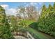 Picturesque backyard featuring mature trees and an attractive retaining wall at 1 Brookhaven Ne Dr # 301, Atlanta, GA 30319