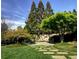 Green backyard with landscaped stone path, plants, trees, and manicured lawn at 1 Brookhaven Ne Dr # 301, Atlanta, GA 30319