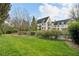 Well-manicured lawn and garden area in backyard with iron fence and multi-story home in the background at 1 Brookhaven Ne Dr # 301, Atlanta, GA 30319