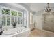 Bright and airy bathroom with a soaking tub, a separate glass shower, and large windows offering plenty of natural light at 1 Brookhaven Ne Dr # 301, Atlanta, GA 30319