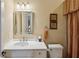 Traditional bathroom with a vanity, decorative mirror, and wall sconces, showcasing classic design elements at 1 Brookhaven Ne Dr # 301, Atlanta, GA 30319