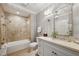 Bathroom featuring marble tile, glass shower, large vanity, and a well lit mirror at 1 Brookhaven Ne Dr # 301, Atlanta, GA 30319