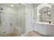 Elegant bathroom features marble shower, a bench, and white cabinetry, offering a serene and spa-like experience at 1 Brookhaven Ne Dr # 301, Atlanta, GA 30319