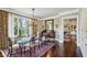 Elegant dining room with hardwood floors, chandelier, and large windows offering a view of the greenery outside at 1 Brookhaven Ne Dr # 301, Atlanta, GA 30319