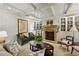 Living room showcasing a stone fireplace, custom built-ins, comfortable seating, and decor at 1 Brookhaven Ne Dr # 301, Atlanta, GA 30319