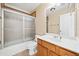 Bright bathroom with tub/shower, wooden cabinets, and tile floors at 3420 Aviary Ln, Acworth, GA 30101