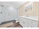 Modern bathroom with glass shower, sleek white vanity, and wood floor at 3420 Aviary Ln, Acworth, GA 30101