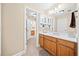 Bathroom featuring tan walls, wood cabinets, a large mirror and tile floors at 3420 Aviary Ln, Acworth, GA 30101