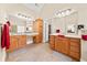 Bright bathroom featuring double sinks with wooden cabinets and a separate makeup vanity at 3420 Aviary Ln, Acworth, GA 30101