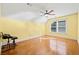 Bedroom features hardwood floors, a ceiling fan, and yellow walls at 3420 Aviary Ln, Acworth, GA 30101