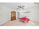 Bedroom featuring a ceiling fan, wardrobe, and red coverlet at 3420 Aviary Ln, Acworth, GA 30101