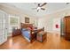 Inviting bedroom features hardwood floors, soft lighting, and a comfortable bed with classic decor at 3420 Aviary Ln, Acworth, GA 30101