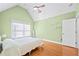 Bright bedroom featuring hardwood floors, a ceiling fan, and light green walls at 3420 Aviary Ln, Acworth, GA 30101