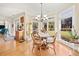 Sunlit breakfast nook with hardwood floors, chandelier, and views of the landscaped backyard at 3420 Aviary Ln, Acworth, GA 30101