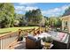 Outdoor living on a wooden deck with comfortable seating, potted plants, and views of the landscaped yard at 3420 Aviary Ln, Acworth, GA 30101