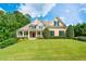 Charming two-story home with a manicured lawn and a welcoming front porch at 3420 Aviary Ln, Acworth, GA 30101