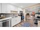 Updated kitchen featuring stainless steel appliances, white cabinets, and a modern design with a view into the living room at 3420 Aviary Ln, Acworth, GA 30101