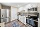 Modern kitchen with stainless steel appliances, white cabinets, and hardwood floors at 3420 Aviary Ln, Acworth, GA 30101
