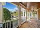 Inviting porch with stone flooring, white columns and railings, and a charming view of the neighborhood at 3420 Aviary Ln, Acworth, GA 30101