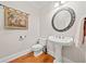 Cozy powder room features a pedestal sink, decorative mirror, and elegant wall decor at 3420 Aviary Ln, Acworth, GA 30101
