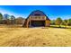 Large barn featuring a second story deck and large garage doors at 3625 Pointer Rd, Loganville, GA 30052