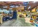 Unfinished basement with exposed wood beams, tool chests, and cabinets offering storage and work space at 3625 Pointer Rd, Loganville, GA 30052