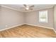 Bedroom featuring hardwood floors, neutral walls, white trim, ceiling fan, and a window at 3625 Pointer Rd, Loganville, GA 30052