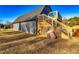 Close-up of barn featuring wooden stairs to a deck, siding, and plenty of space at 3625 Pointer Rd, Loganville, GA 30052