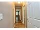 Hallway featuring wood floors, neutral walls, white trim, and doors leading to various rooms at 3625 Pointer Rd, Loganville, GA 30052