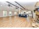 Open-concept kitchen and living room with hardwood floors, a stone fireplace, and a blue kitchen island at 3625 Pointer Rd, Loganville, GA 30052