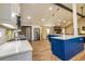 Bright kitchen with stainless steel appliances, a blue kitchen island, and hardwood floors at 3625 Pointer Rd, Loganville, GA 30052