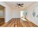 Inviting living room with wood floors, featuring a decorative front door and ceiling fan at 3625 Pointer Rd, Loganville, GA 30052