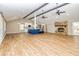 Open-concept living room with stone fireplace and wooden beams at 3625 Pointer Rd, Loganville, GA 30052