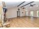 Spacious living room with a stone fireplace, vaulted ceilings, wood beams, and hardwood floors at 3625 Pointer Rd, Loganville, GA 30052