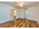 Spacious living room featuring wood floors, multiple doorways, and ample closet space at 3625 Pointer Rd, Loganville, GA 30052