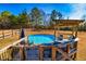 Pool with a deck, pergola, seating and mature trees creating a relaxing oasis at 3625 Pointer Rd, Loganville, GA 30052
