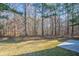 Spacious backyard with mature trees and patio at 6959 Biscayne Blvd, Rex, GA 30273