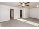 Bright bedroom with gray carpeting and ceiling fan at 1347 Sunny Lake Dr, Lawrenceville, GA 30043