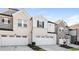 Three-unit townhome building with attached garages and light-grey brick at 1347 Sunny Lake Dr, Lawrenceville, GA 30043