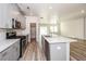 Modern kitchen with gray cabinets, island, and stainless steel appliances at 1347 Sunny Lake Dr, Lawrenceville, GA 30043