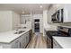 Modern kitchen with gray cabinets, stainless steel appliances and access to garage at 1347 Sunny Lake Dr, Lawrenceville, GA 30043