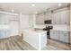 Modern kitchen with gray cabinets, quartz countertops, and stainless steel appliances at 1347 Sunny Lake Dr, Lawrenceville, GA 30043