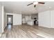 Open living room with gray kitchen, island, and vinyl plank flooring at 1347 Sunny Lake Dr, Lawrenceville, GA 30043