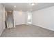 Spacious loft area with gray carpeting and access to upstairs bedroom at 1347 Sunny Lake Dr, Lawrenceville, GA 30043