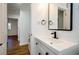 Bathroom with modern vanity, black hardware, and wood-look floors at 474 Fairlock Nw Ln, Atlanta, GA 30331