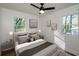 Cozy bedroom with a ceiling fan, bedside tables, and decorative pillows and art at 474 Fairlock Nw Ln, Atlanta, GA 30331