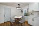 Bright dining area with a round table, modern lighting, and access to the kitchen at 474 Fairlock Nw Ln, Atlanta, GA 30331